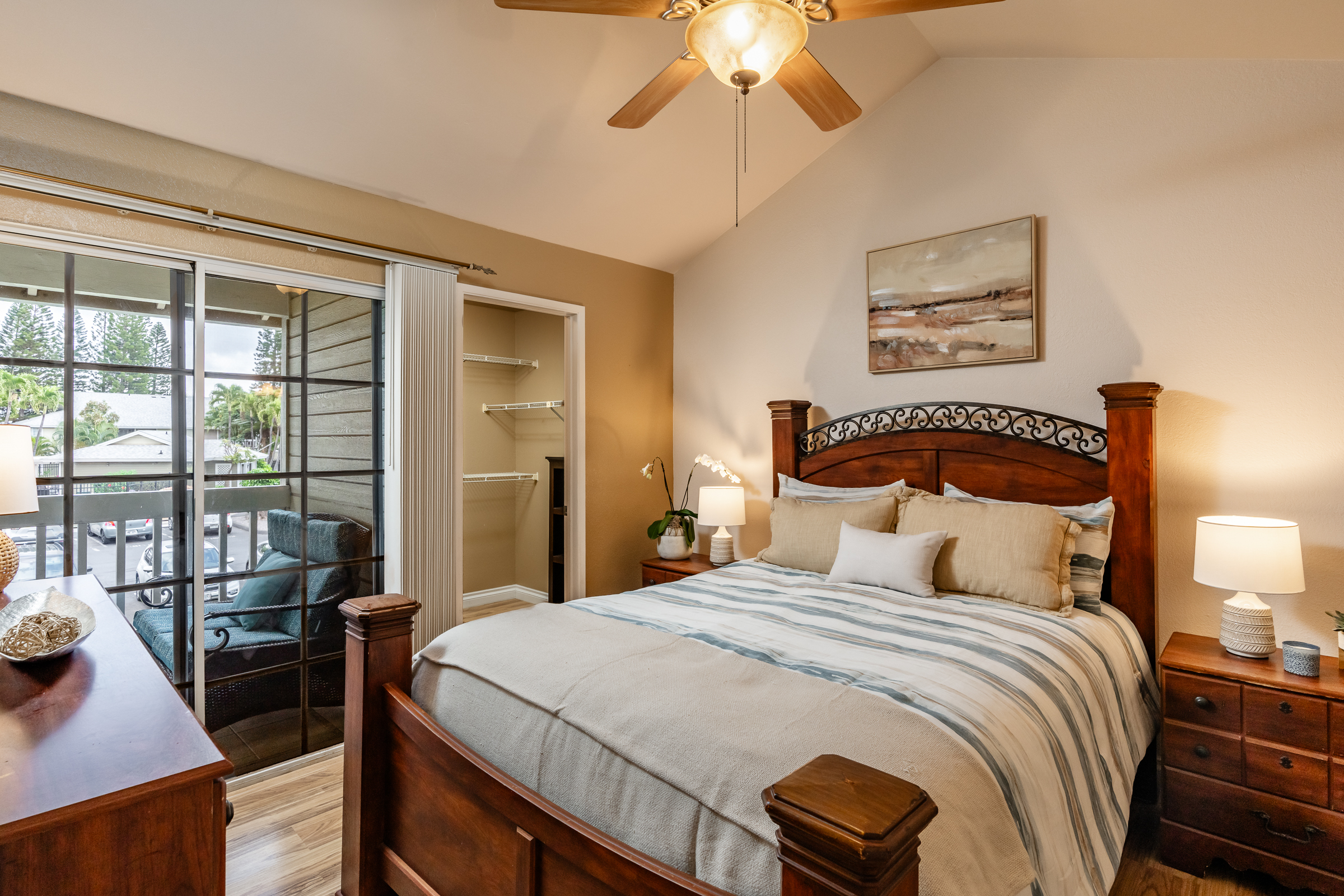 68-3883 Lua Kula Street, Unit 2106 Waikoloa, HI 96738 - Photo 5 of 13 a bedroom with a large bed and a chandelier