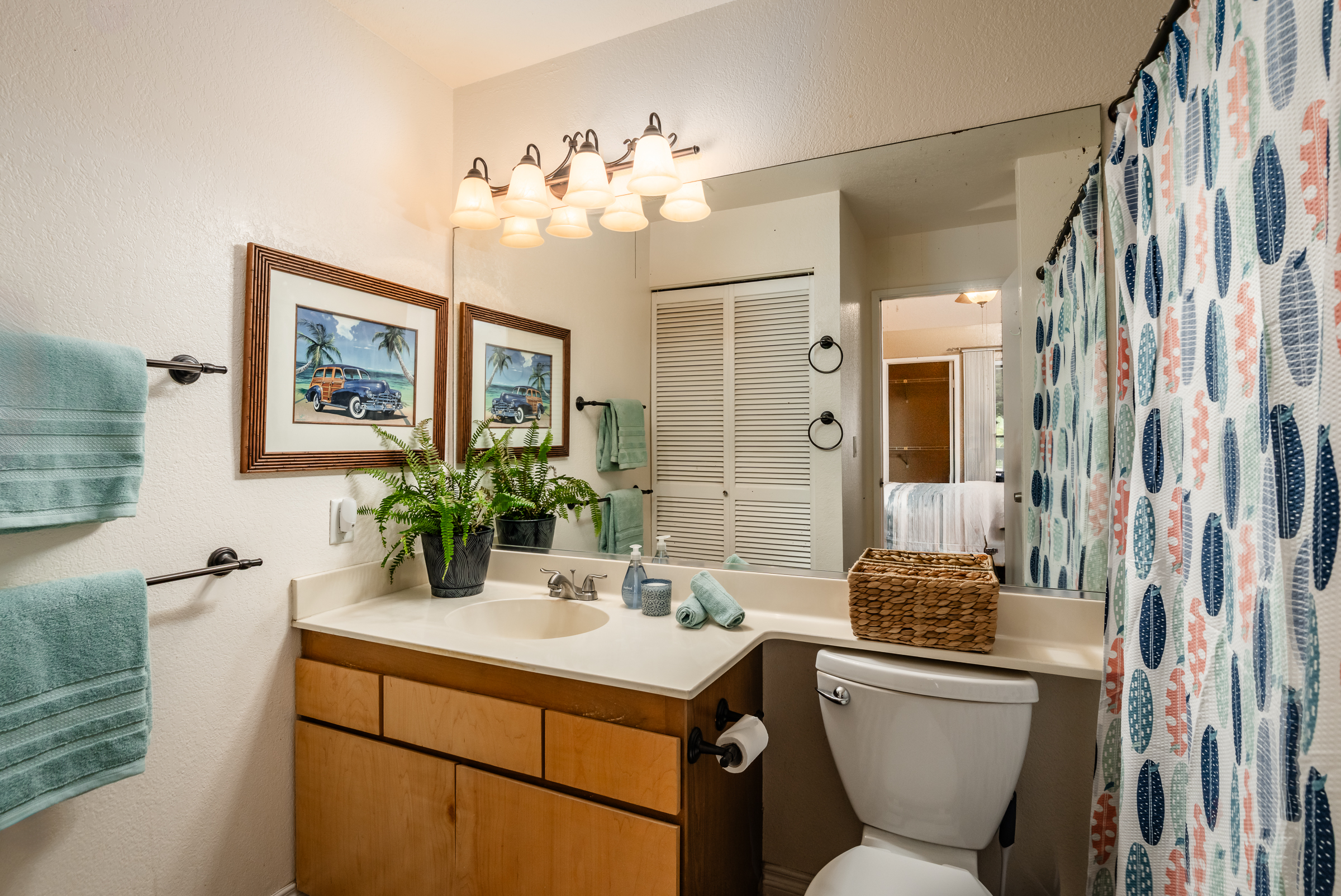 68-3883 Lua Kula Street, Unit 2106 Waikoloa, HI 96738 - Photo 6 of 13 a bathroom with a toilet sink and mirror