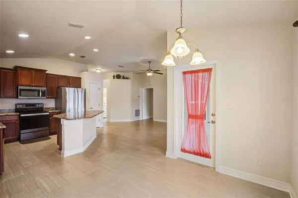 a view of a kitchen with a sink and stainless steel appliances