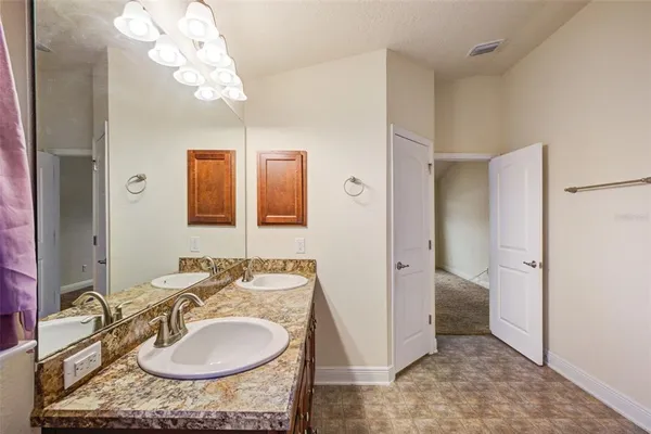 a bathroom with a sink double vanity and a mirror