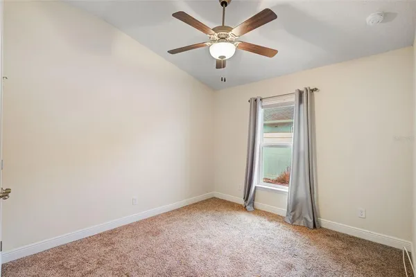 an empty room with a ceiling fan