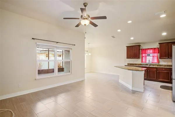 a open kitchen with stainless steel appliances granite countertop a stove and a sink