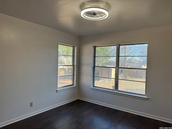 a view of a hallway with wooden floor and a sink