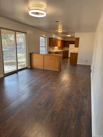 a kitchen with stainless steel appliances granite countertop a sink a stove and a wooden floors