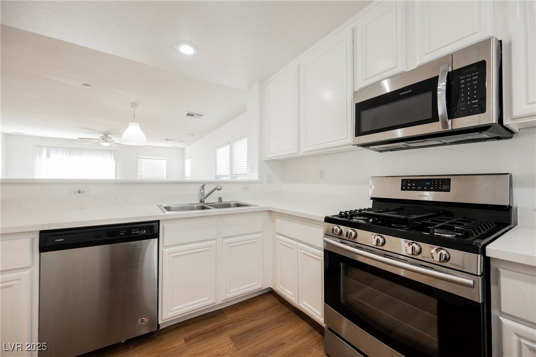1161 Gecko Road Henderson, NV 89002 - Photo 24 of 54 Kitchen with stainless steel appliances, ceiling fan, light countertops, white cabinetry, and recessed lighting