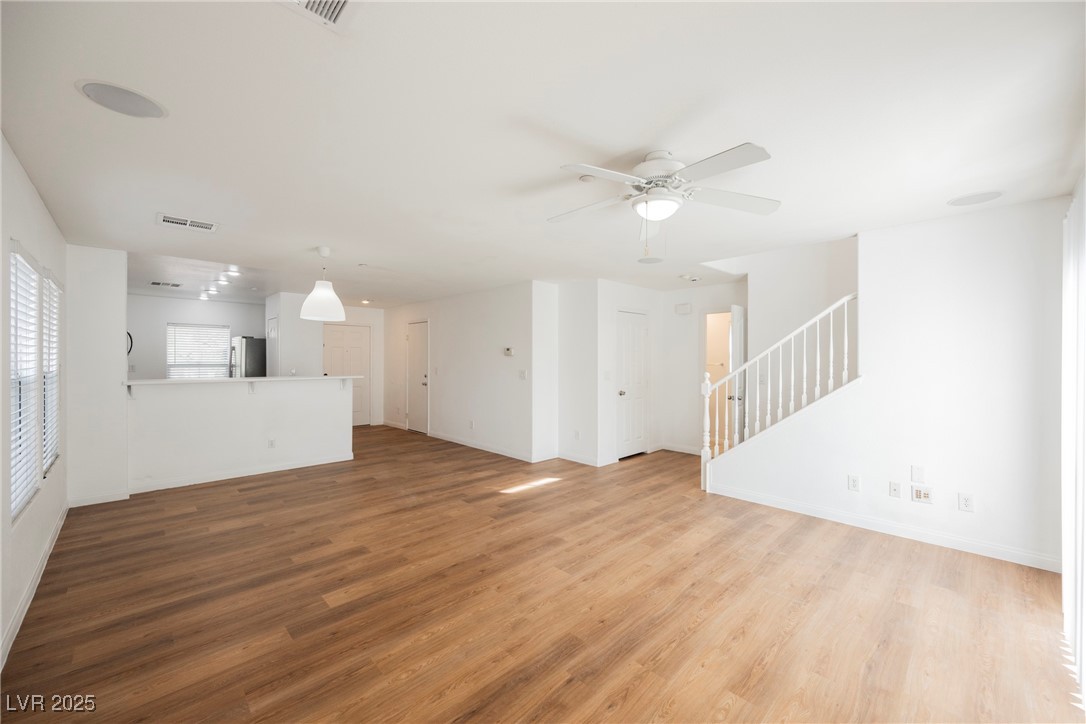 1161 Gecko Road Henderson, NV 89002 - Photo 26 of 54 Unfurnished living room with wood finished floors, stairs, and ceiling fan