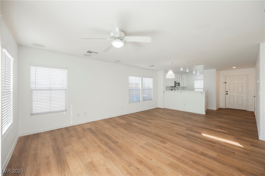 1161 Gecko Road Henderson, NV 89002 - Photo 27 of 54 Unfurnished living room with light wood-type flooring and ceiling fan