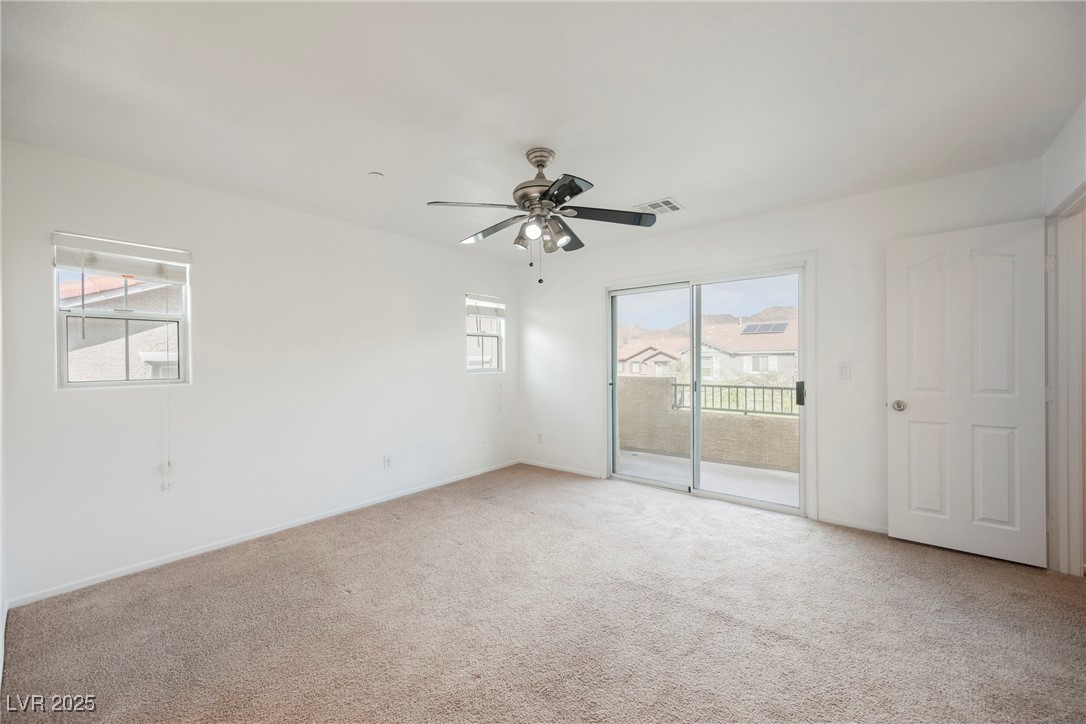 1161 Gecko Road Henderson, NV 89002 - Photo 31 of 54 Empty room with light carpet and a ceiling fan