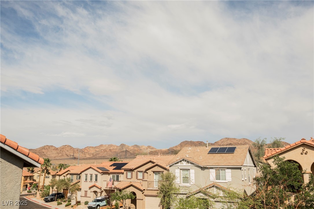 1161 Gecko Road Henderson, NV 89002 - Photo 39 of 54 View of front facade with a residential view, a tiled roof, stucco siding, and solar panels