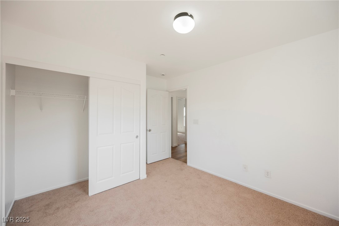 1161 Gecko Road Henderson, NV 89002 - Photo 41 of 54 Unfurnished bedroom featuring light carpet and a closet