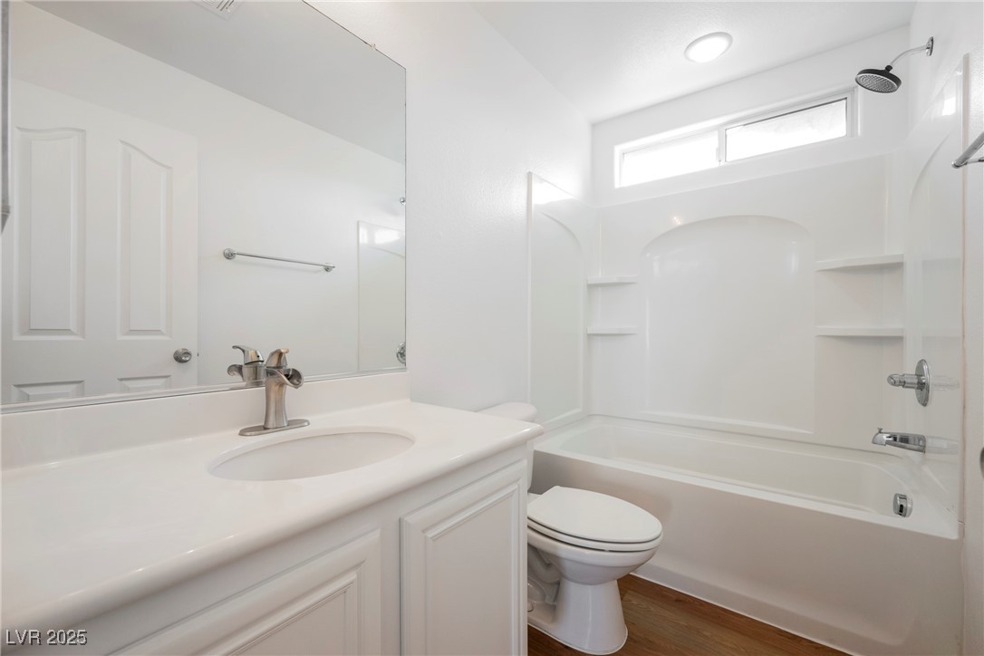 1161 Gecko Road Henderson, NV 89002 - Photo 42 of 54 Full bathroom featuring vanity, shower / tub combination, and wood finished floors