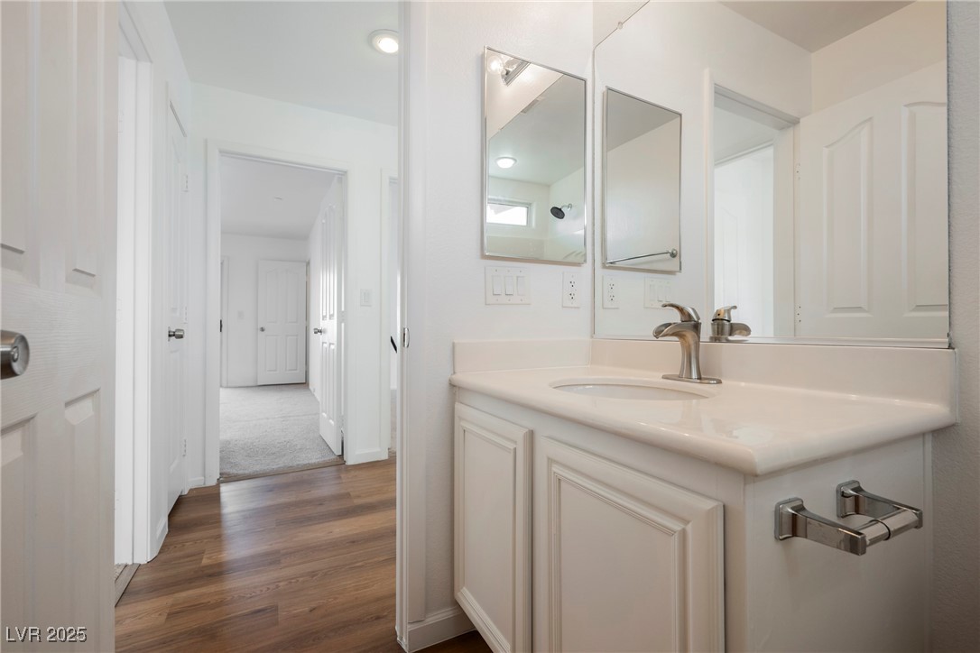 1161 Gecko Road Henderson, NV 89002 - Photo 44 of 54 Bathroom featuring wood finished floors and vanity