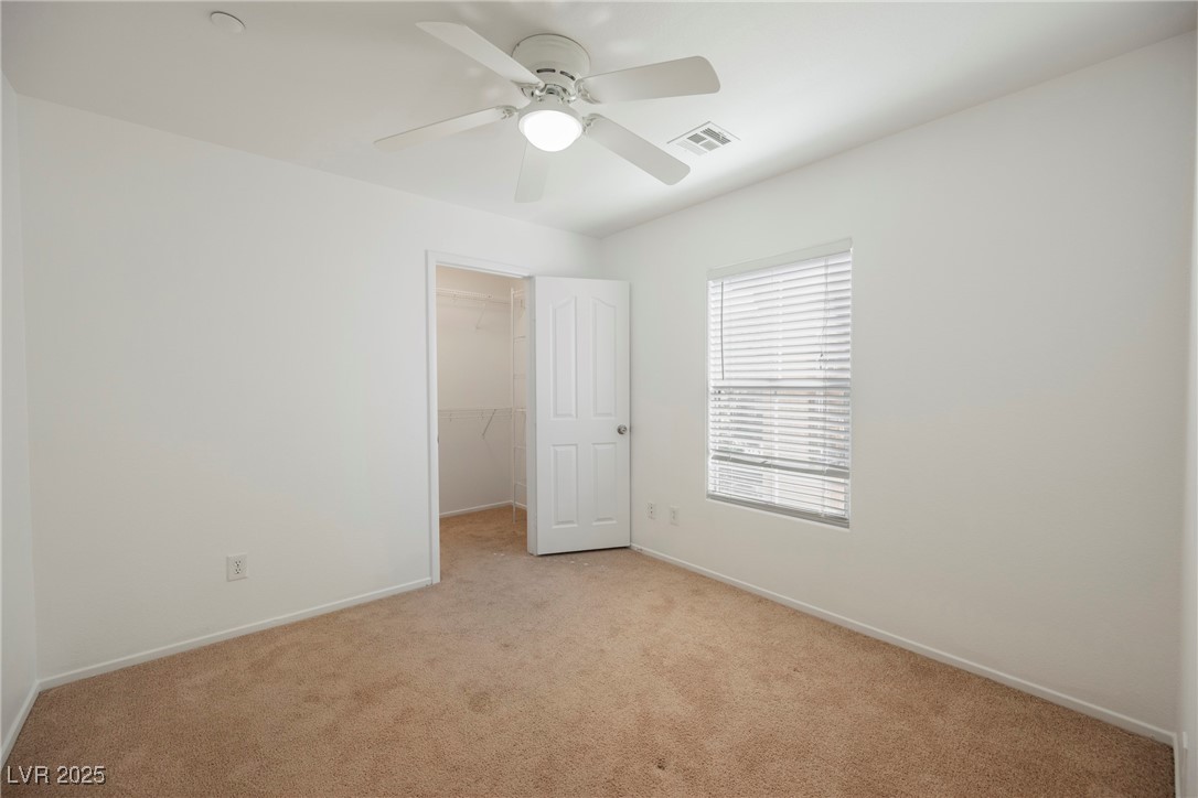 1161 Gecko Road Henderson, NV 89002 - Photo 46 of 54 Unfurnished bedroom with light carpet, a walk in closet, a closet, and ceiling fan