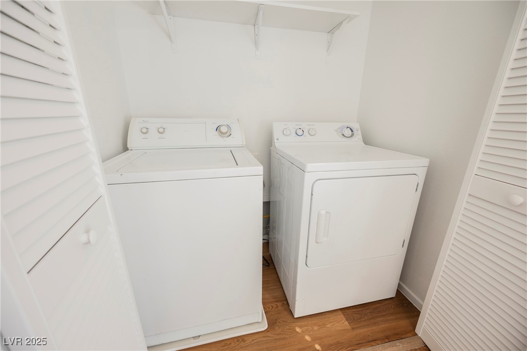 1161 Gecko Road Henderson, NV 89002 - Photo 49 of 54 Washroom with washing machine and clothes dryer and light wood-style floors