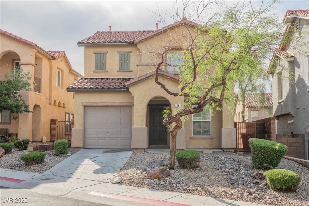 1161 Gecko Road Henderson, NV 89002 - Photo 5 of 54 Mediterranean / spanish house with a tile roof, stucco siding, an attached garage, driveway, and a gate