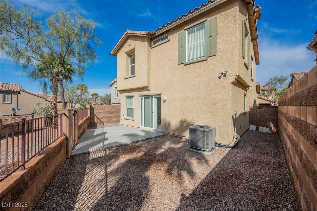 1161 Gecko Road Henderson, NV 89002 - Photo 9 of 54 Back of property featuring stucco siding, a patio, a fenced backyard, and a tile roof