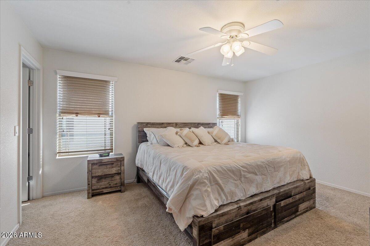 1255 South Rialto, Unit 106 Mesa, AZ 85209 - Photo 4 of 32 a bedroom with a bed a chandelier and a chandelier