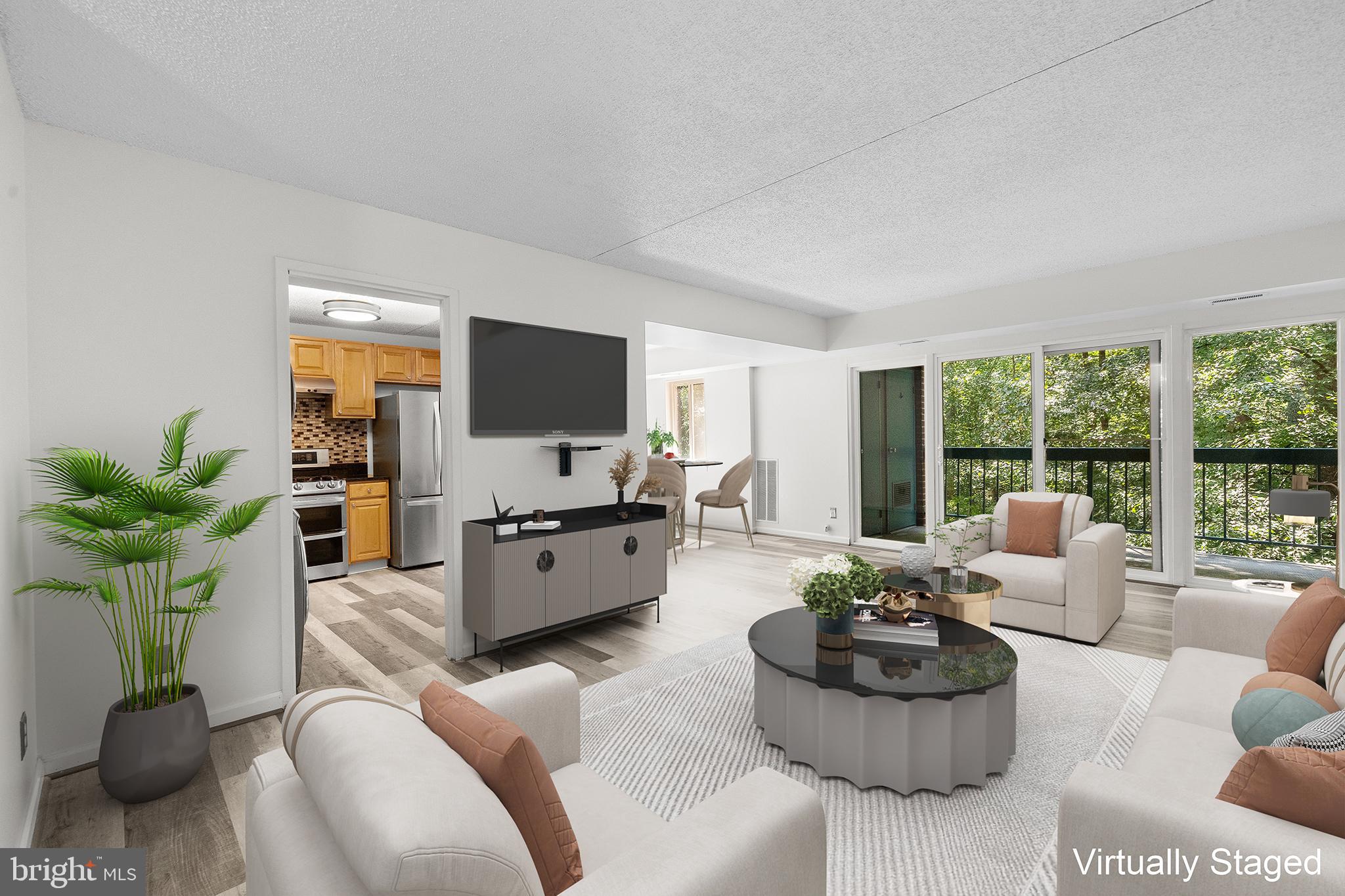 11835 Shire Court, Unit 12C Reston, VA 20191 - Photo 1 of 28 a living room with furniture flat screen tv and a large window