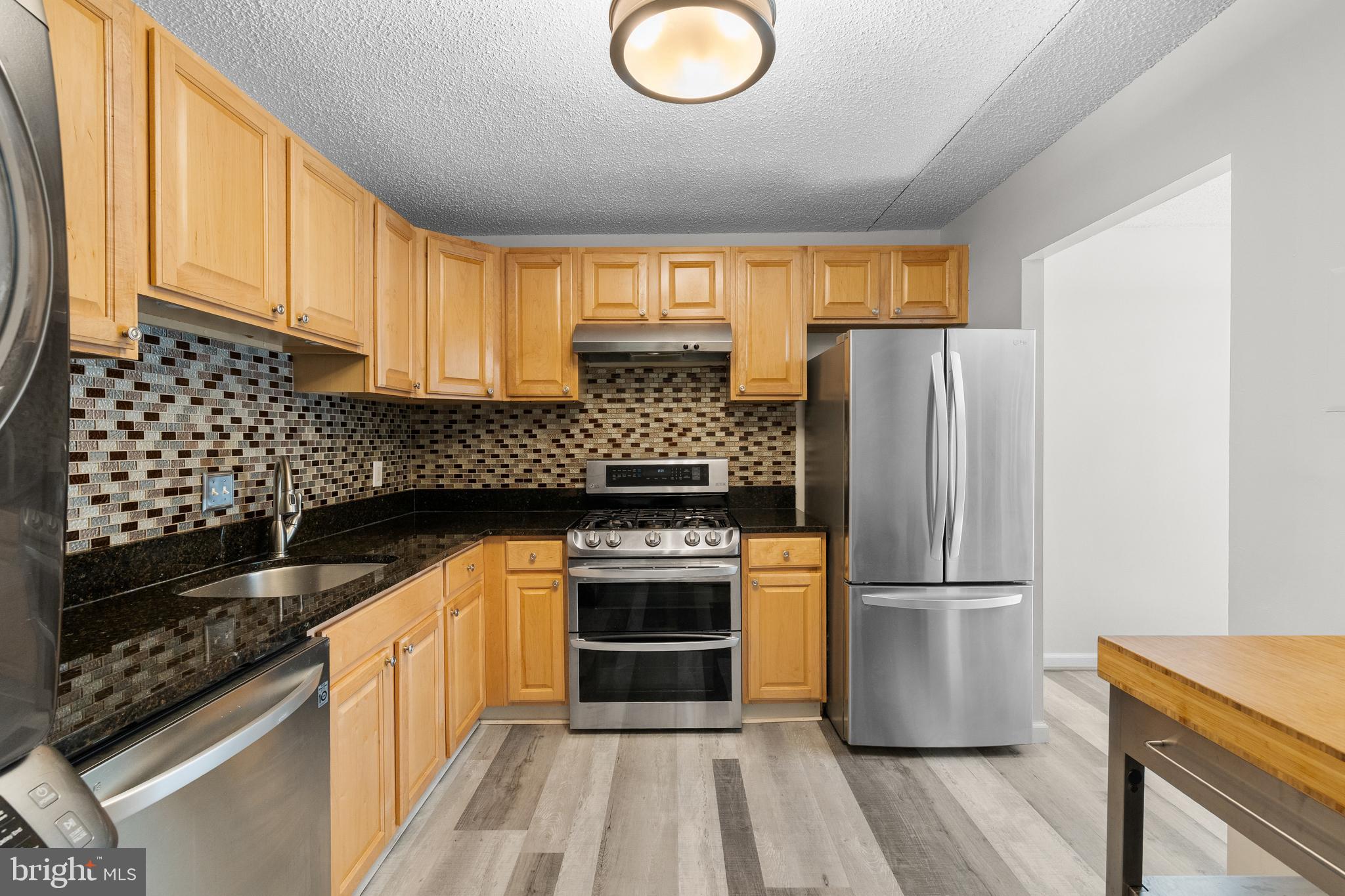 11835 Shire Court, Unit 12C Reston, VA 20191 - Photo 12 of 28 a kitchen with a refrigerator and a sink