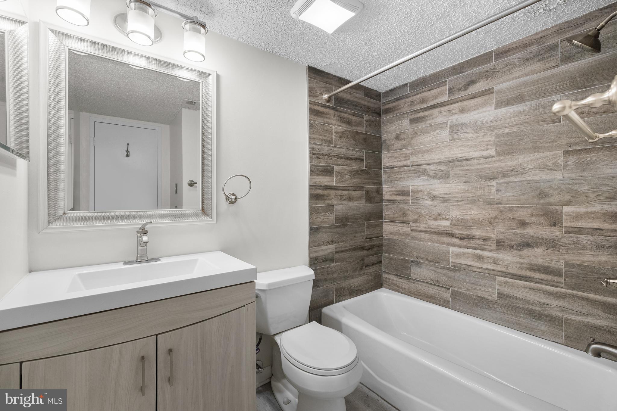11835 Shire Court, Unit 12C Reston, VA 20191 - Photo 18 of 28 a bathroom with a sink and a mirror