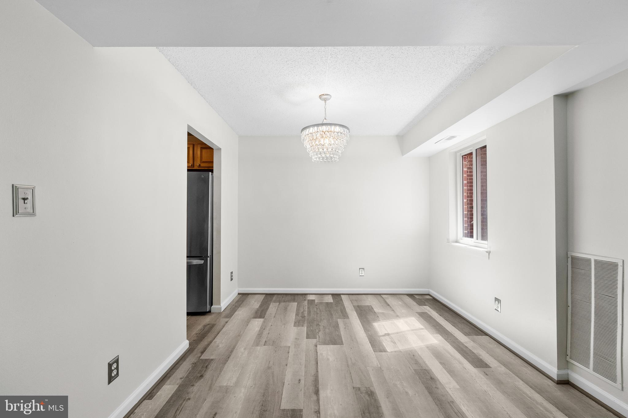 11835 Shire Court, Unit 12C Reston, VA 20191 - Photo 7 of 28 a view of empty room with wooden floor