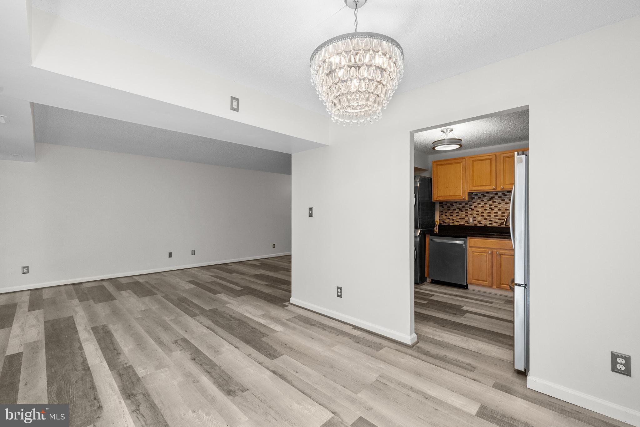 11835 Shire Court, Unit 12C Reston, VA 20191 - Photo 9 of 28 a view of an empty room and a kitchen