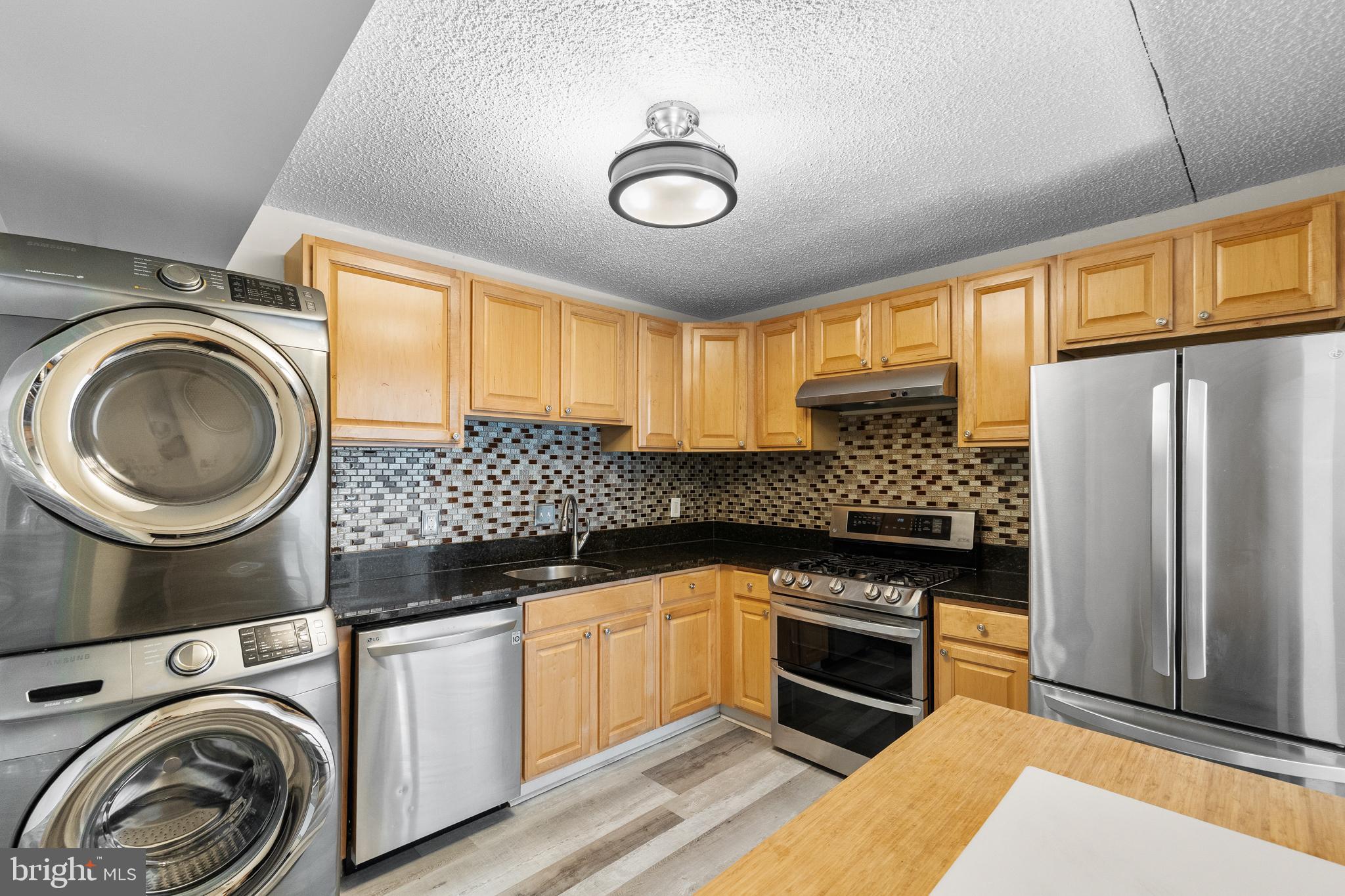 11835 Shire Court, Unit 12C Reston, VA 20191 - Photo 10 of 28 a kitchen with a stove a sink and a refrigerator