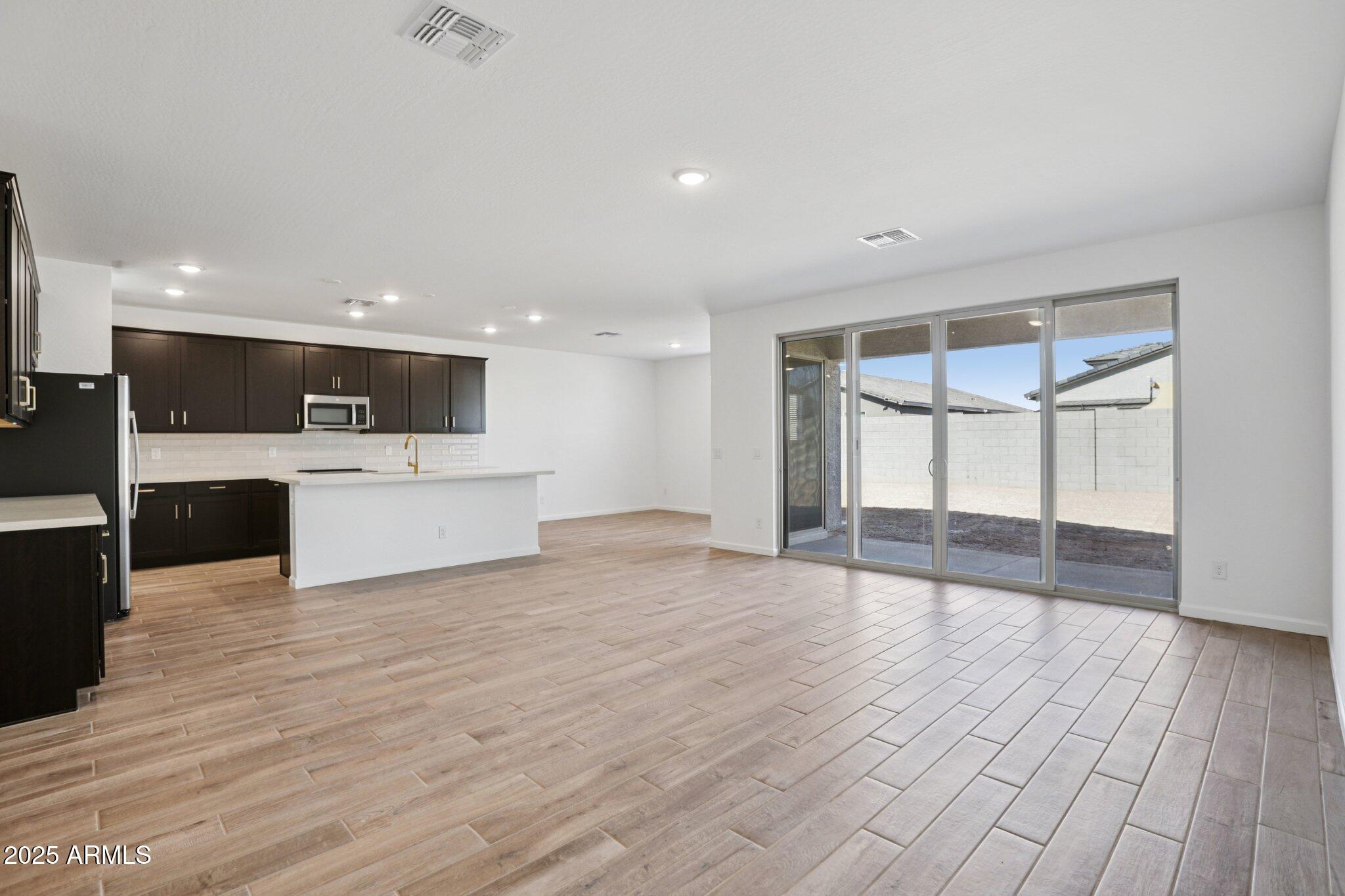 15722 West Brown Street Waddell, AZ 85355 - Photo 12 of 61 a view of kitchen with wooden floor and electronic appliances