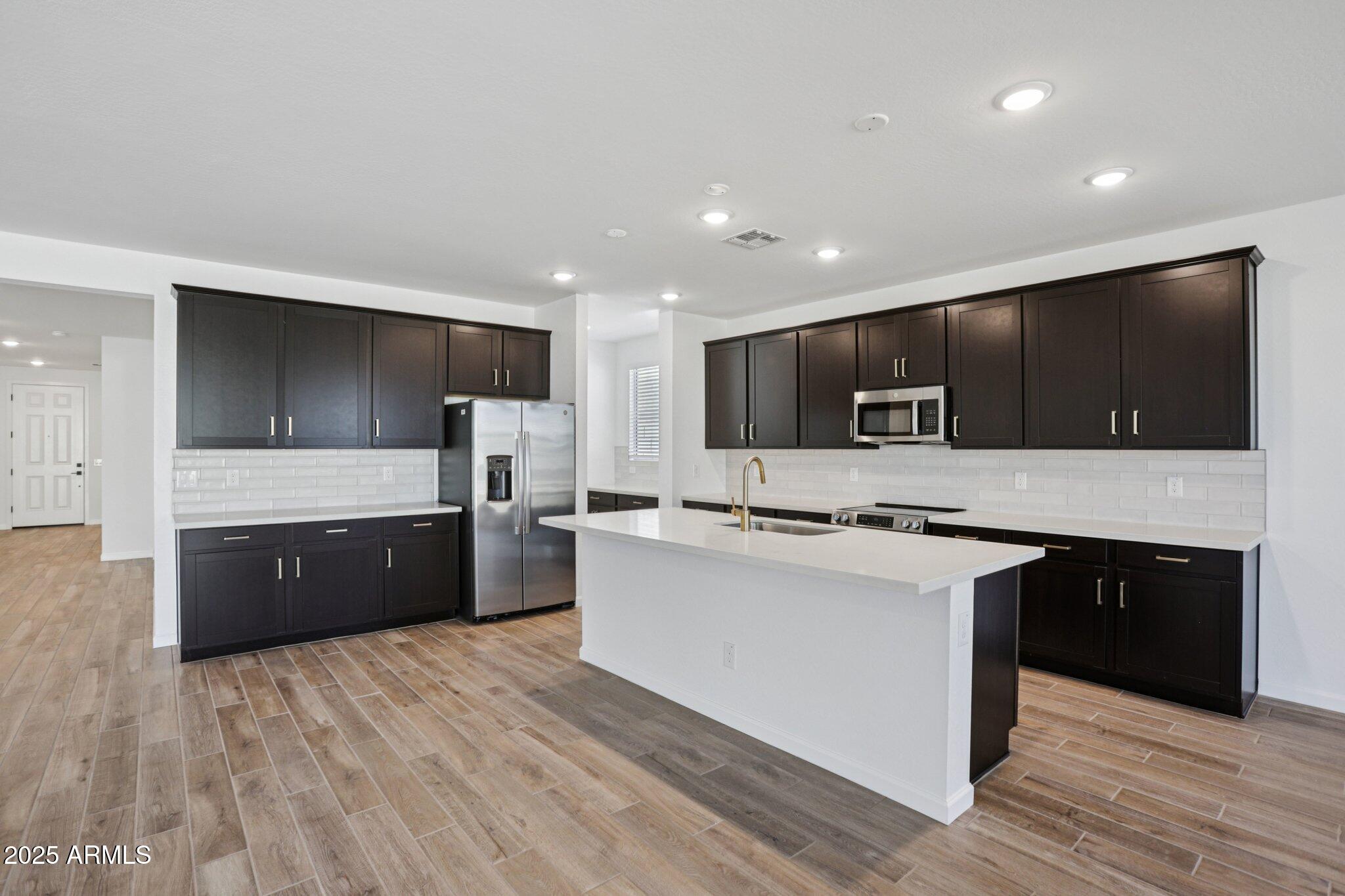 15722 West Brown Street Waddell, AZ 85355 - Photo 13 of 61 a large kitchen with stainless steel appliances lots of counter top space
