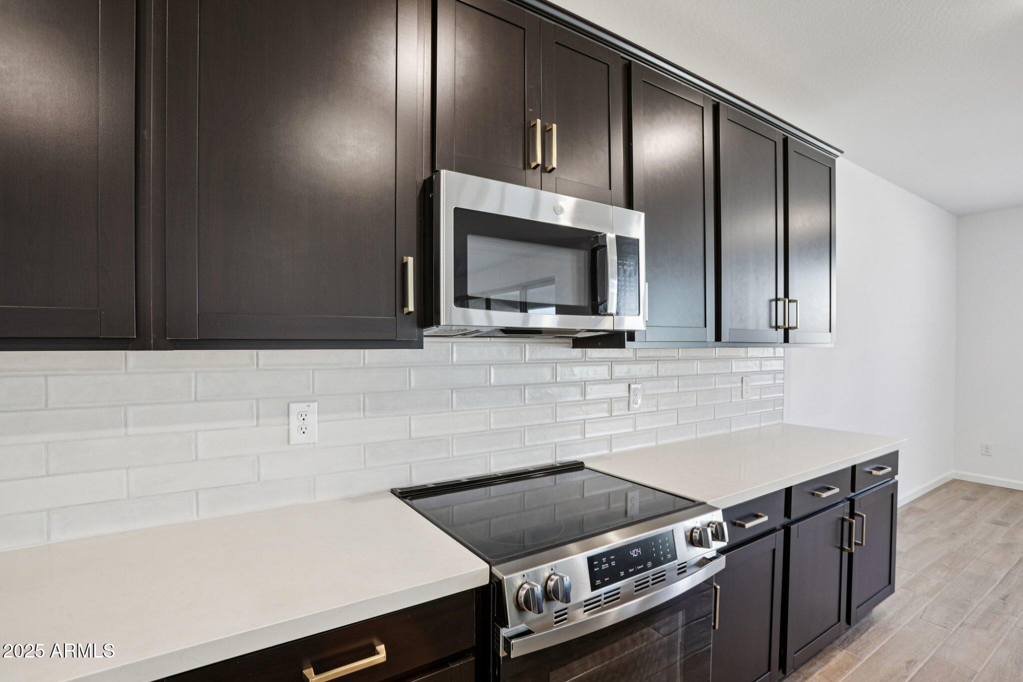 15722 West Brown Street Waddell, AZ 85355 - Photo 17 of 61 a kitchen with a sink and a microwave