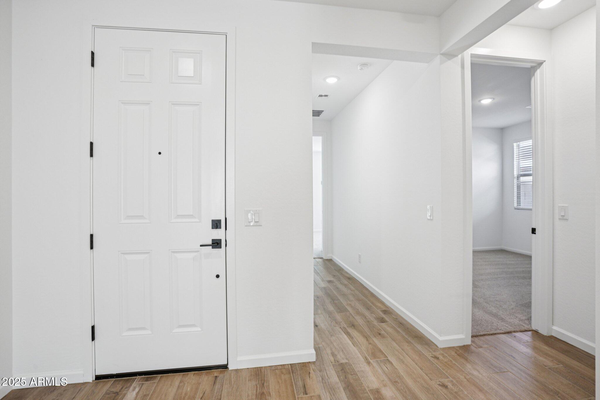 15722 West Brown Street Waddell, AZ 85355 - Photo 5 of 61 a view of a hallway with wooden floor