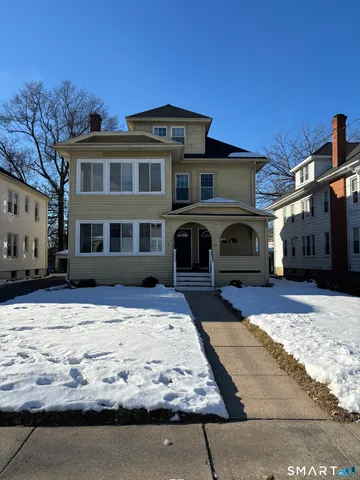 a front view of a building with a yard