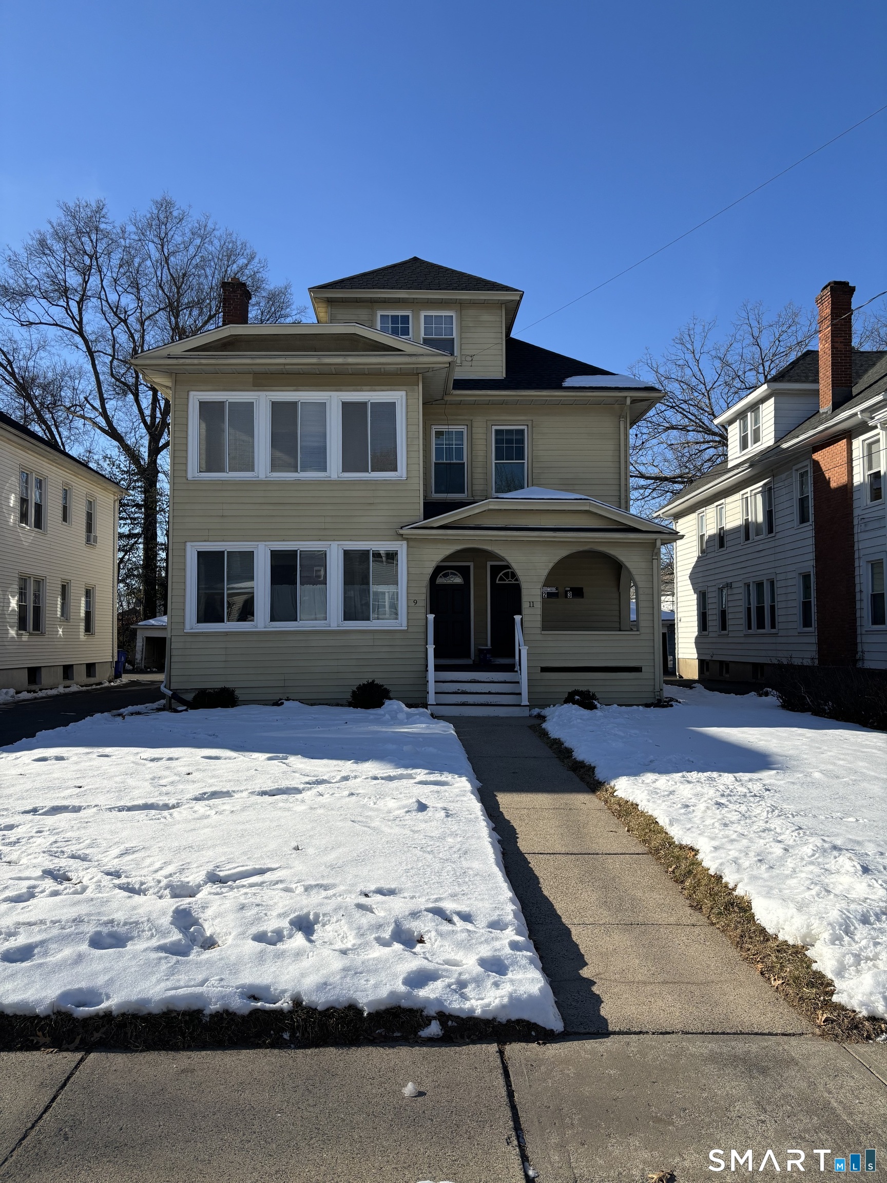 9 Bretton Road, Unit 2 West Hartford, CT 06119 - Photo 1 of 17 a front view of a building with a yard