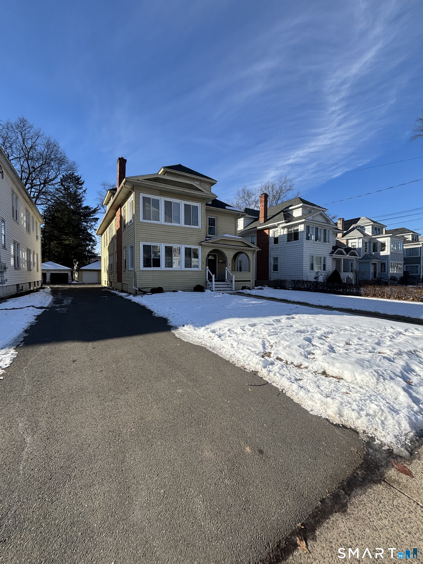 9 Bretton Road, Unit 2 West Hartford, CT 06119 - Photo 2 of 17 a view of a house with a yard