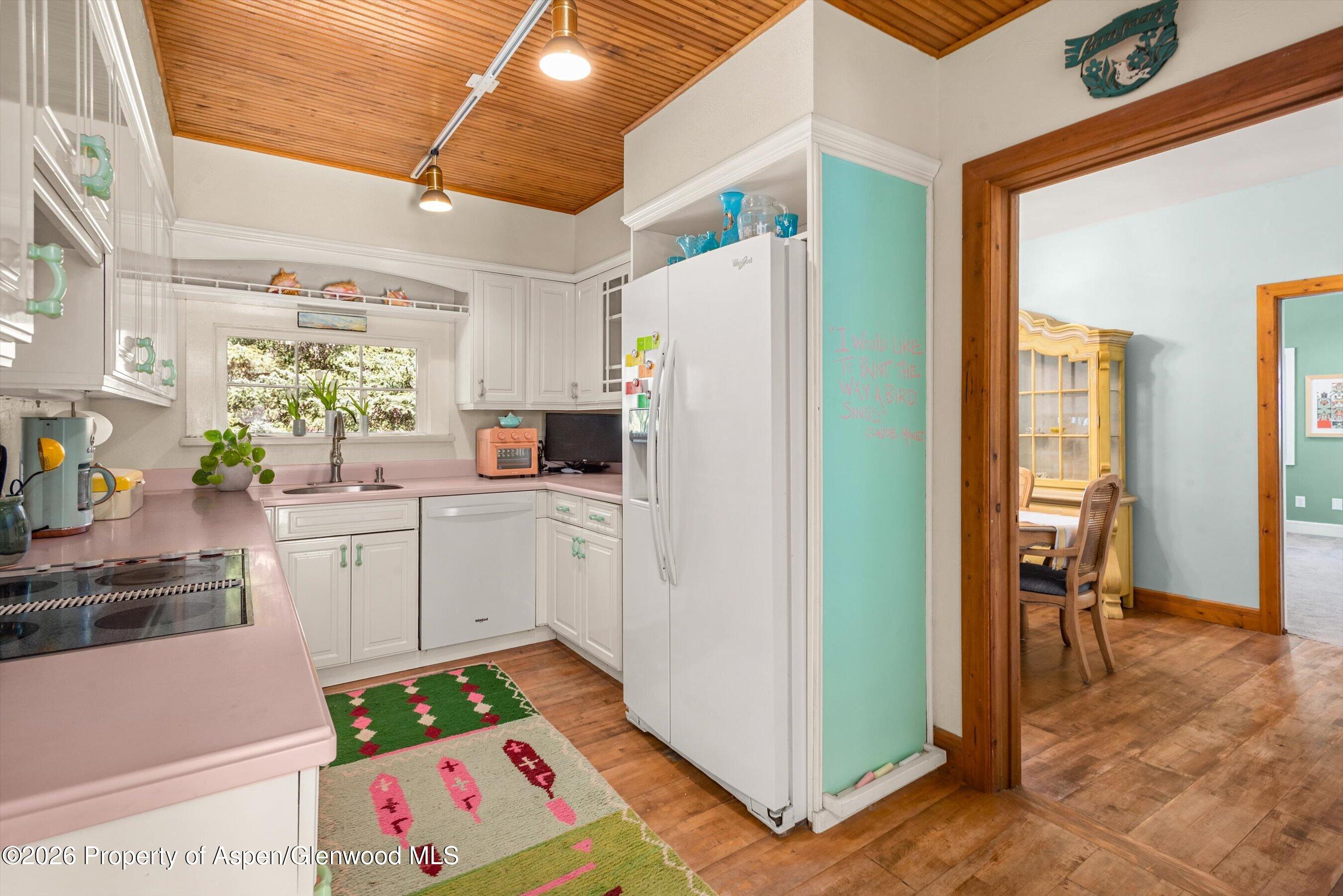 244 Redstone Boulevard Redstone, CO 81623 - Photo 21 of 55 a white refrigerator freezer sitting inside of a kitchen