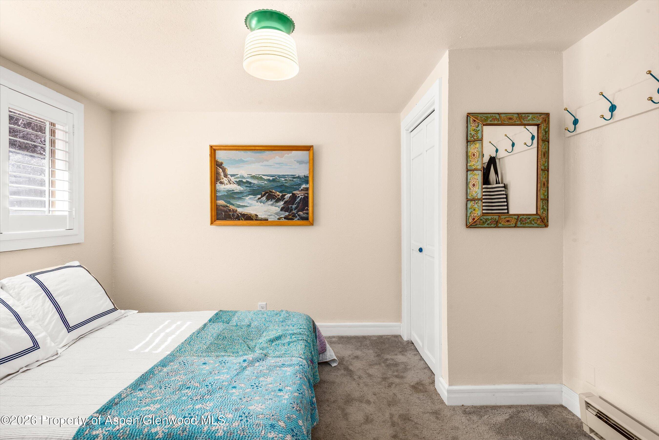 244 Redstone Boulevard Redstone, CO 81623 - Photo 34 of 55 a bedroom with a bed and a painting on the wall
