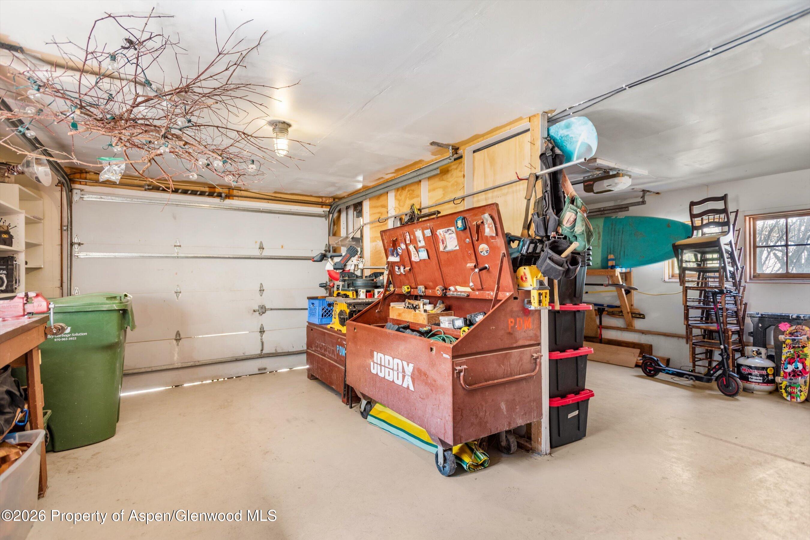 244 Redstone Boulevard Redstone, CO 81623 - Photo 38 of 55 a room with lots of wooden furniture and a chandelier