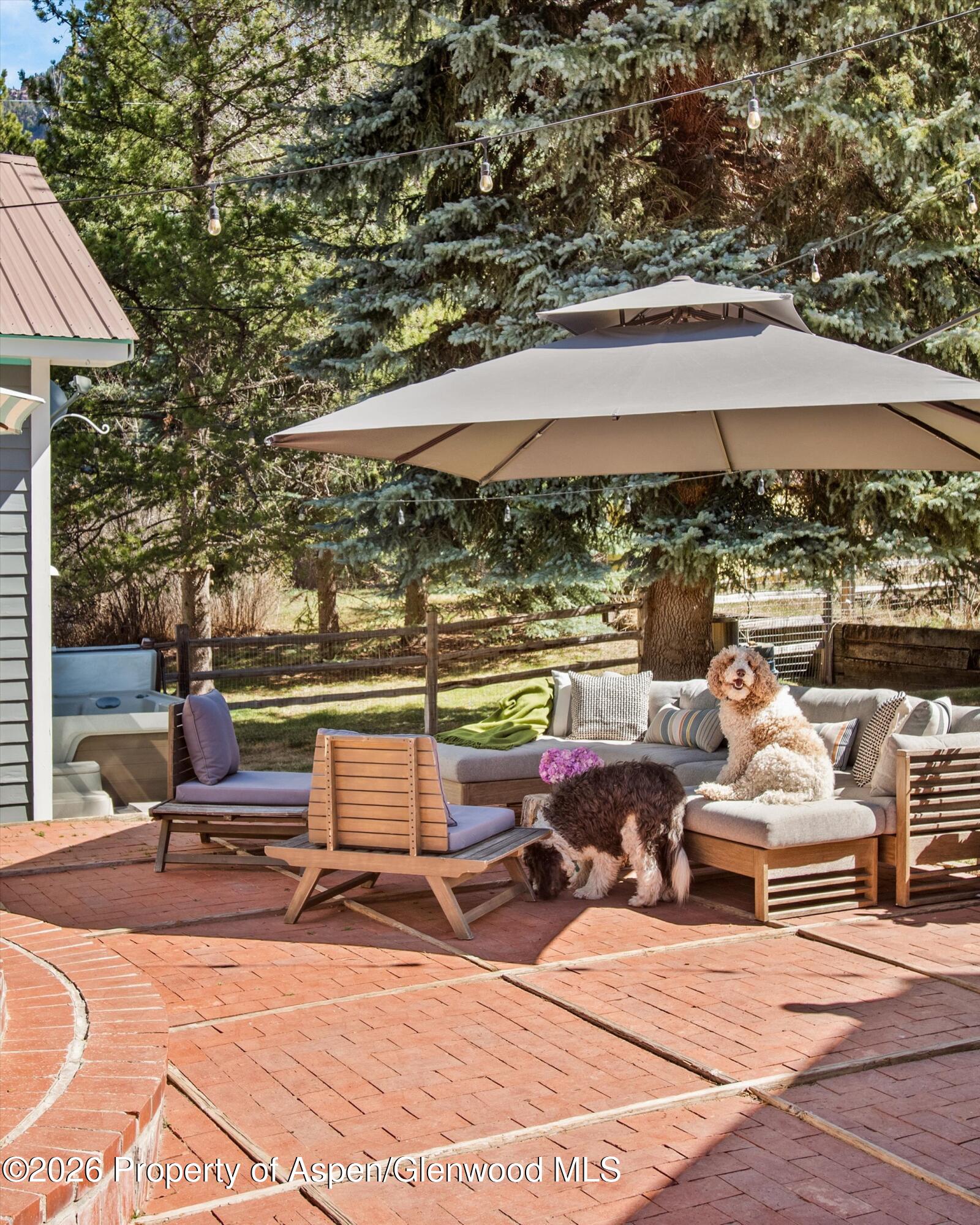 244 Redstone Boulevard Redstone, CO 81623 - Photo 6 of 55 a view of a patio with a table and chairs under an umbrella