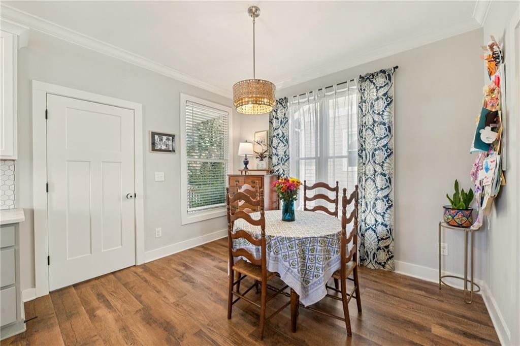 406 Bell Street Monroe, GA 30655 - Photo 15 of 60 a dining room with furniture potted plants and wooden floor