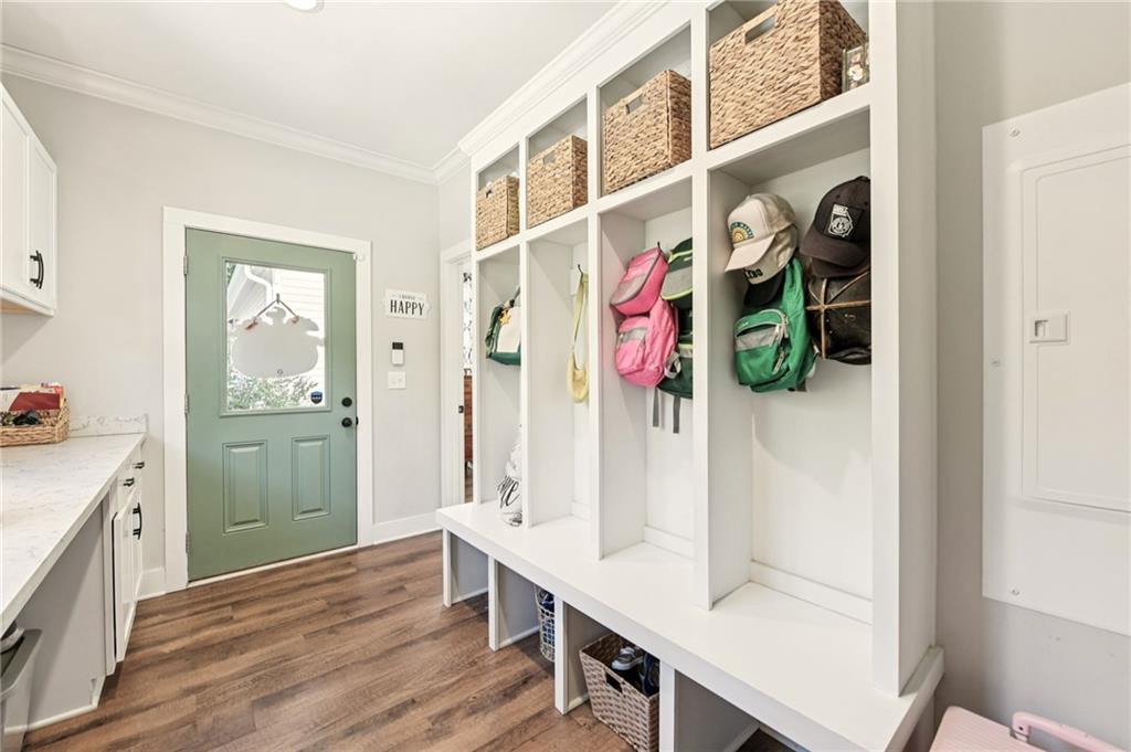 406 Bell Street Monroe, GA 30655 - Photo 25 of 60 a hallway with a white cabinets and wooden floor