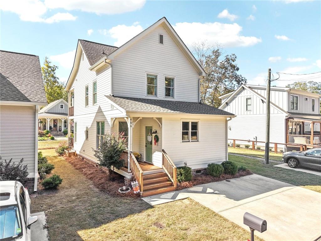 406 Bell Street Monroe, GA 30655 - Photo 3 of 60 a front view of a house with garden