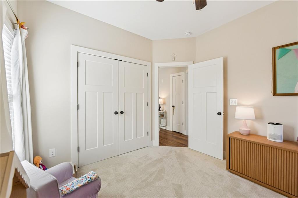 406 Bell Street Monroe, GA 30655 - Photo 33 of 60 a spacious bedroom with a bed and a view of bathroom