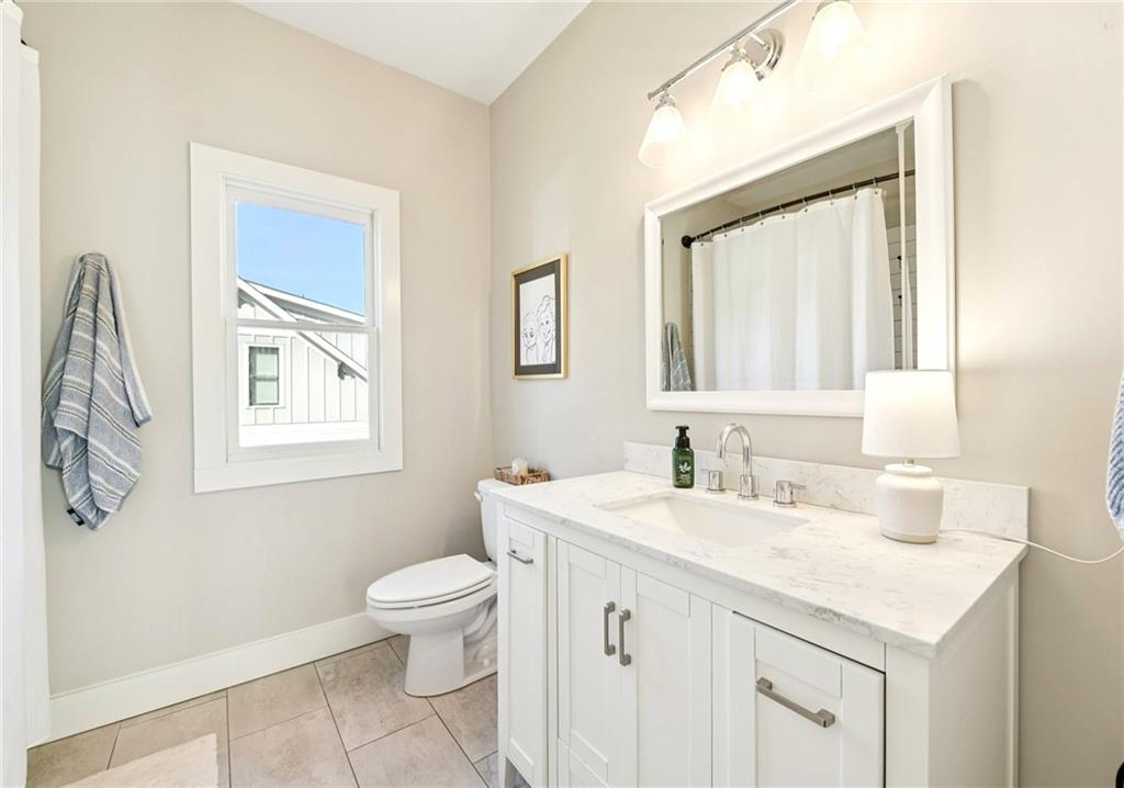406 Bell Street Monroe, GA 30655 - Photo 35 of 60 a bathroom with a sink a toilet and a mirror