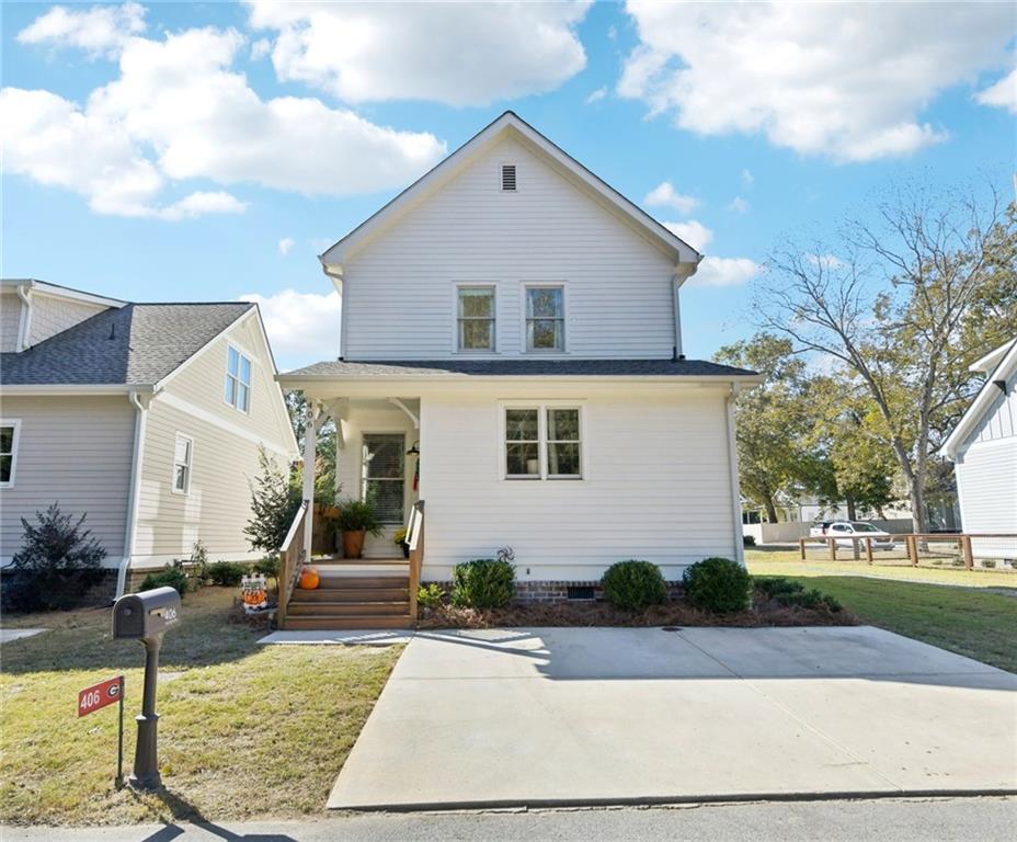 406 Bell Street Monroe, GA 30655 - Photo 42 of 60 a front view of a house with garden