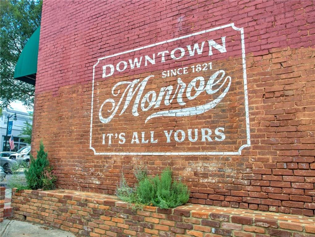 406 Bell Street Monroe, GA 30655 - Photo 53 of 60 a sign on the brick wall