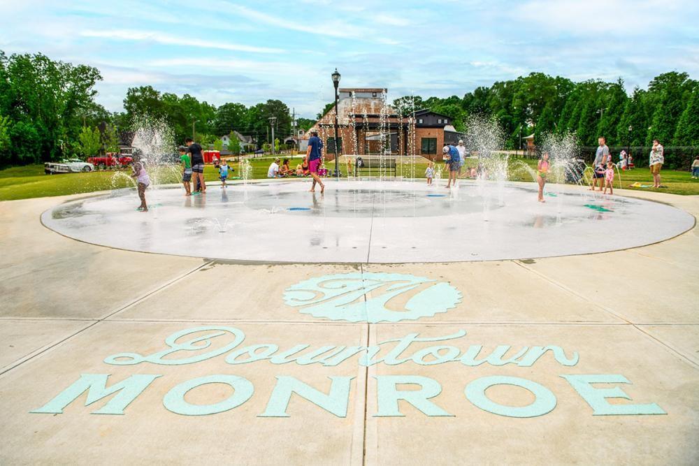 406 Bell Street Monroe, GA 30655 - Photo 54 of 60 a view of a swimming pool with a lawn chairs
