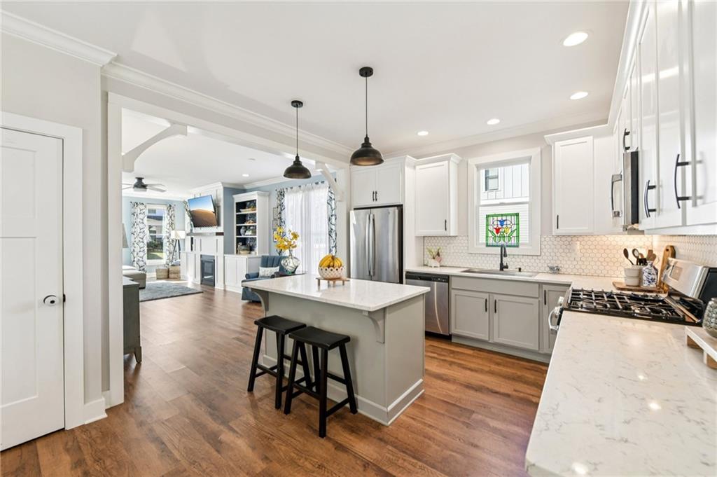 406 Bell Street Monroe, GA 30655 - Photo 7 of 60 a kitchen with sink cabinets and wooden floor