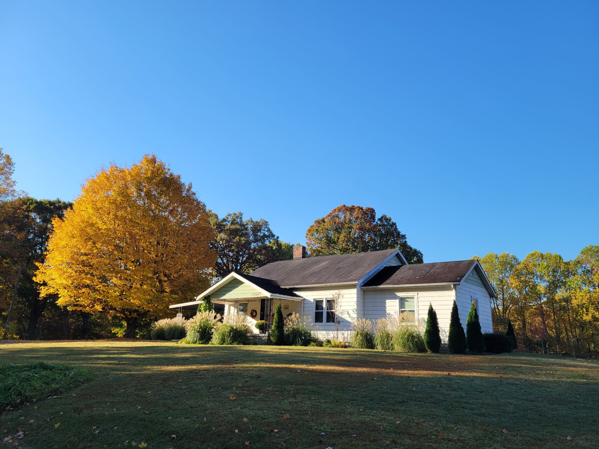 a front view of a house with a garden