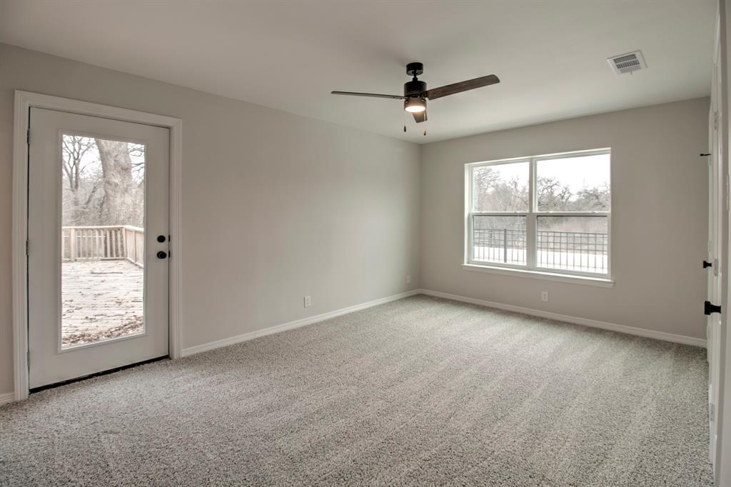 3700 Moseley Road Cross Roads, TX 76227 - Photo 27 of 38 Large Bedroom with two walk in closets, ensuite bathroom, with direct access to the back patio allowing it to be the perfect secondary master.