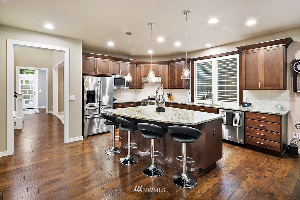 21920 37th Avenue Southeast Bothell, WA 98021 - Photo 12 of 39 a kitchen with stainless steel appliances granite countertop a stove and a refrigerator